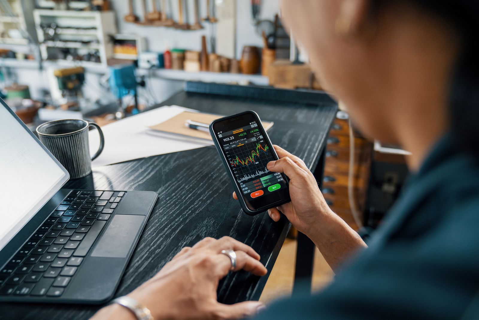 Diverse group of investors using smartphones and laptops to access tokenized equities online, representing global market accessibility and digital finance innovation